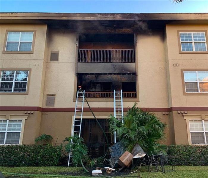 apartment balcony fire aftermath in an Orlando complex building