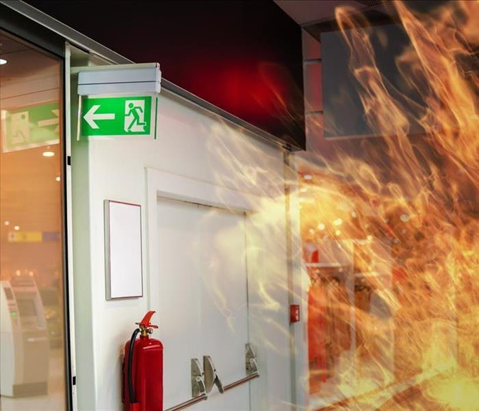 fire in building with fire extinguisher near exit