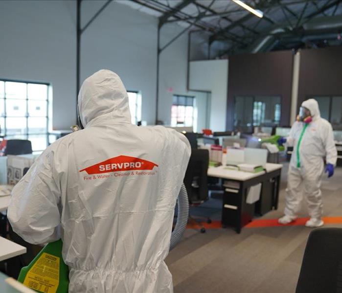 SERVPRO employees wiping down surface with CDC approved products
