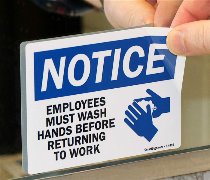removing sticker that reads emplyees must wash hands before returning to work